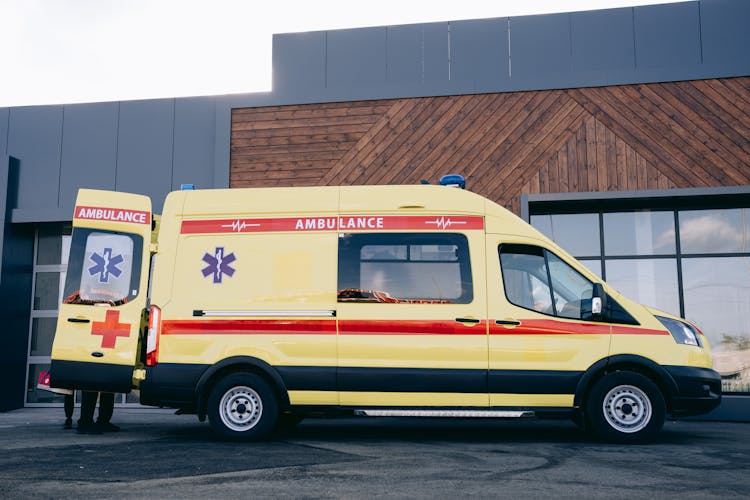 Ambulance Standing In Front Of A Hospital 