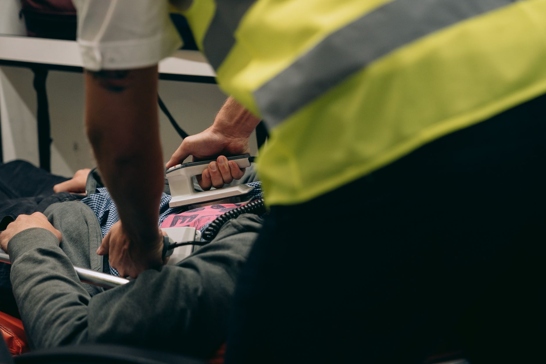 Paramedics provide urgent care to a patient on a stretcher during an emergency situation.