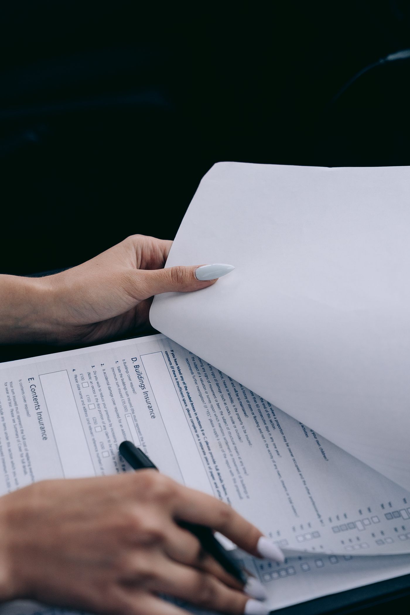 Hands holding a policy document — Standard 7 requires pre-enrollment disclosure, refunds and a grievance procedure.