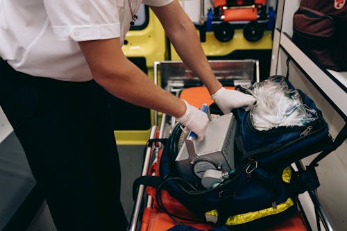 Lifeguard Holding Medical Equipment in an Ambulance 