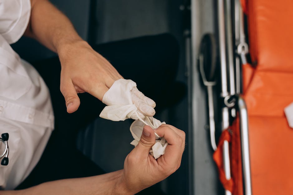Proper glove removal technique showing pinching the outside of one glove and peeling it away, then sliding fingers inside the second glove to remove it without touching the outside - personal protective gear Proper glove removal technique showing pinching the outside of one glove and peeling it away, then sliding fingers inside the second glove to remove it without touching the outside - personal protective gear