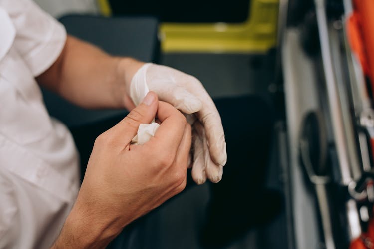 A Paramedic Removing Medical Gloves