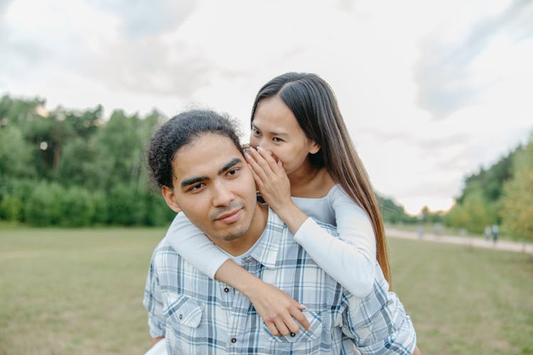 Woman Whispering On A Man