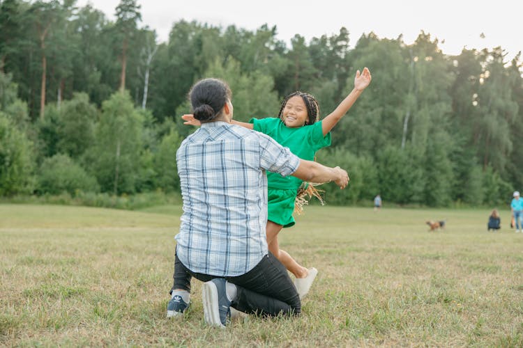 A Young Girl Happily Approaching A Man