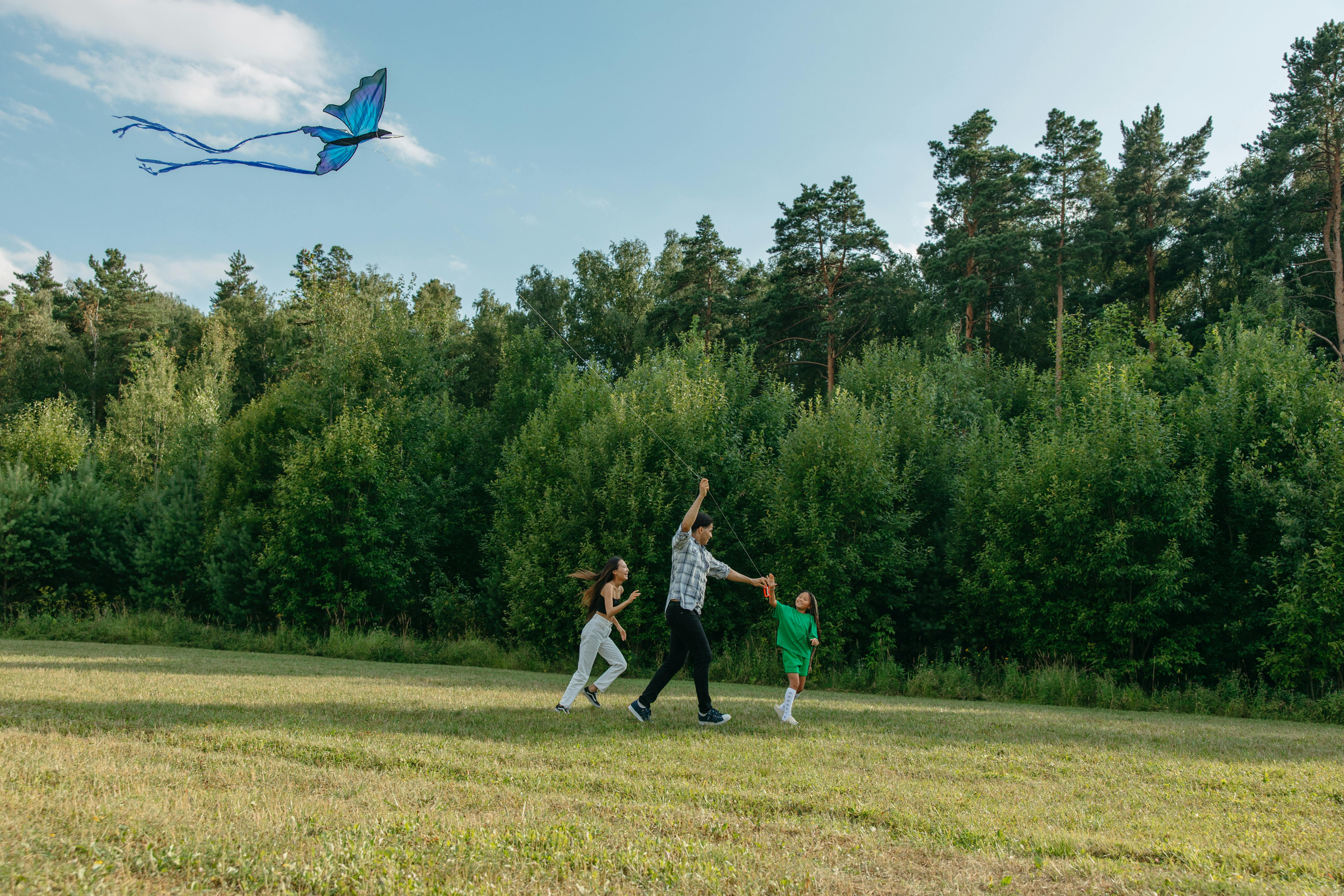 photo of a family playing with a kite together