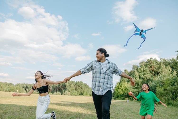 A Family Running In The Park