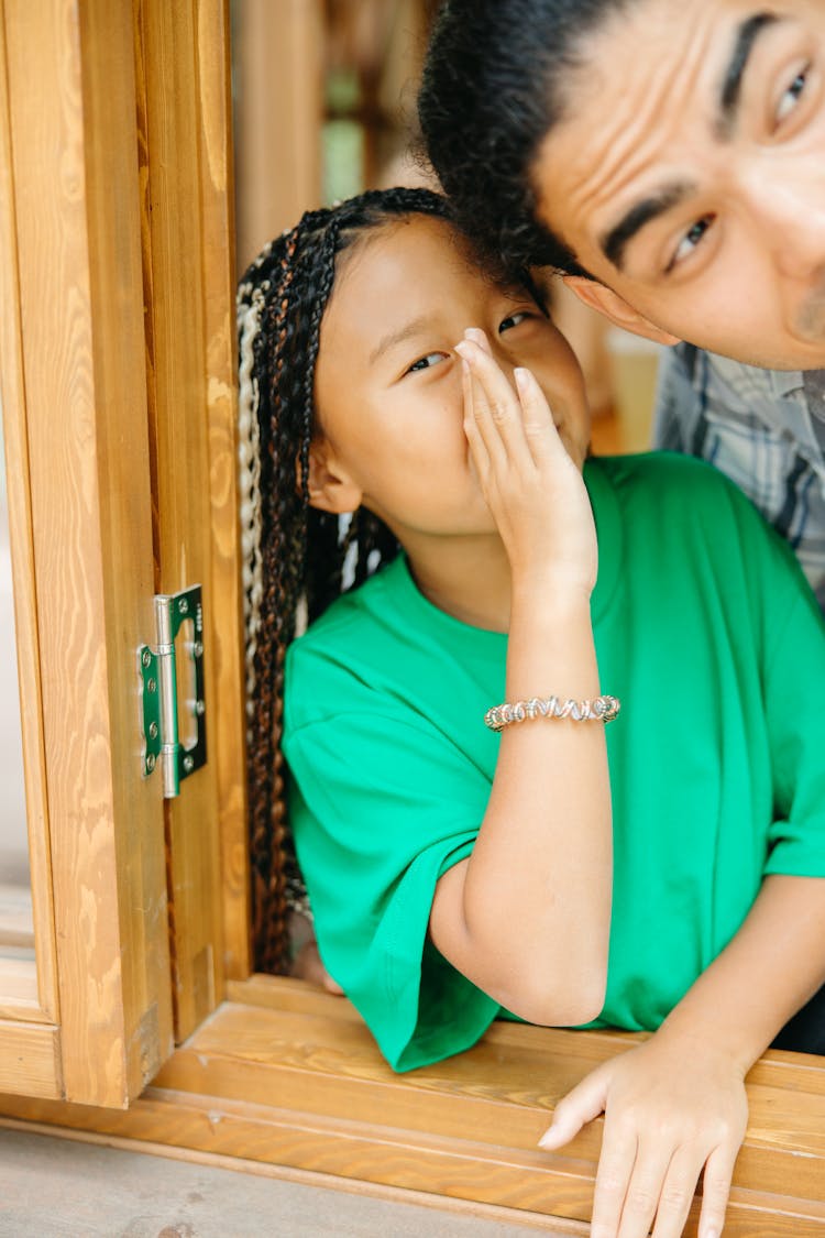 A Girl Whispering To A Person's Ear