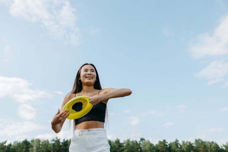 A Woman Holding A Frisbee Disk