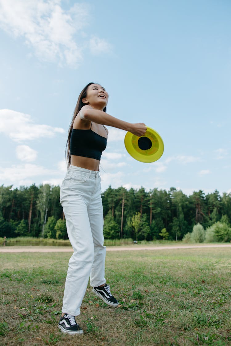 A Woman Playing With A Frisbee