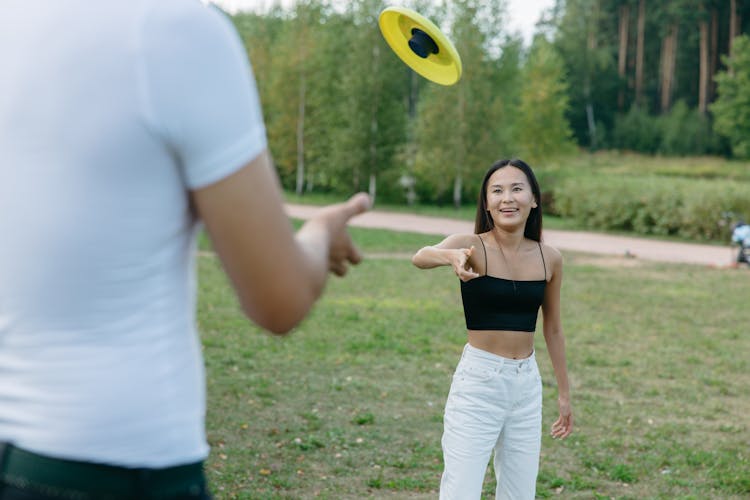 A Woman Throwing A A Frisbee