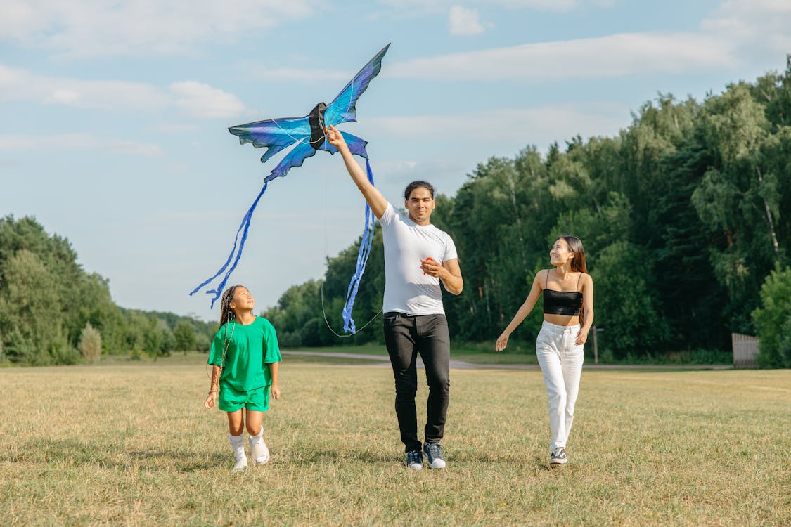 A Family Playing with a Kite in the Park