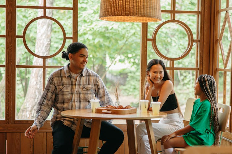 Family Eating Dinner In A Restaurant 