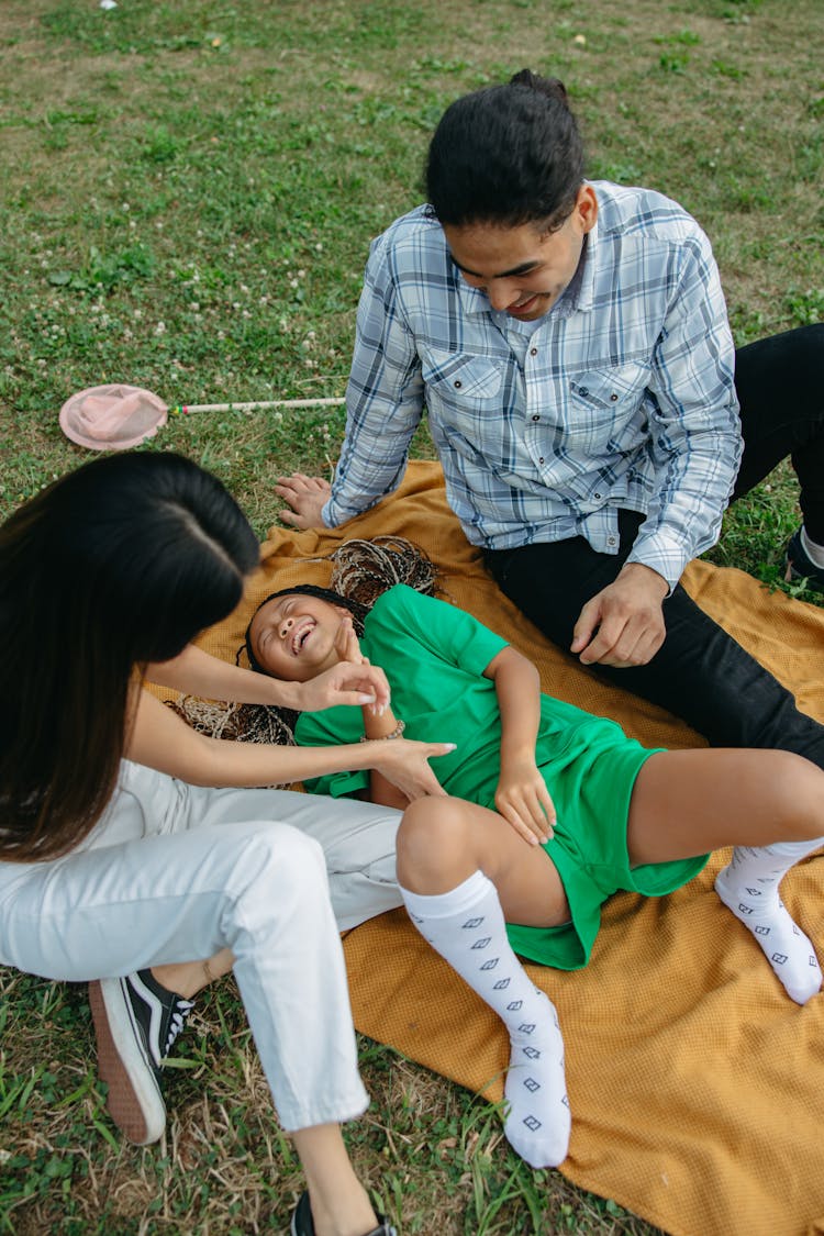 Woman Tickling A Girl