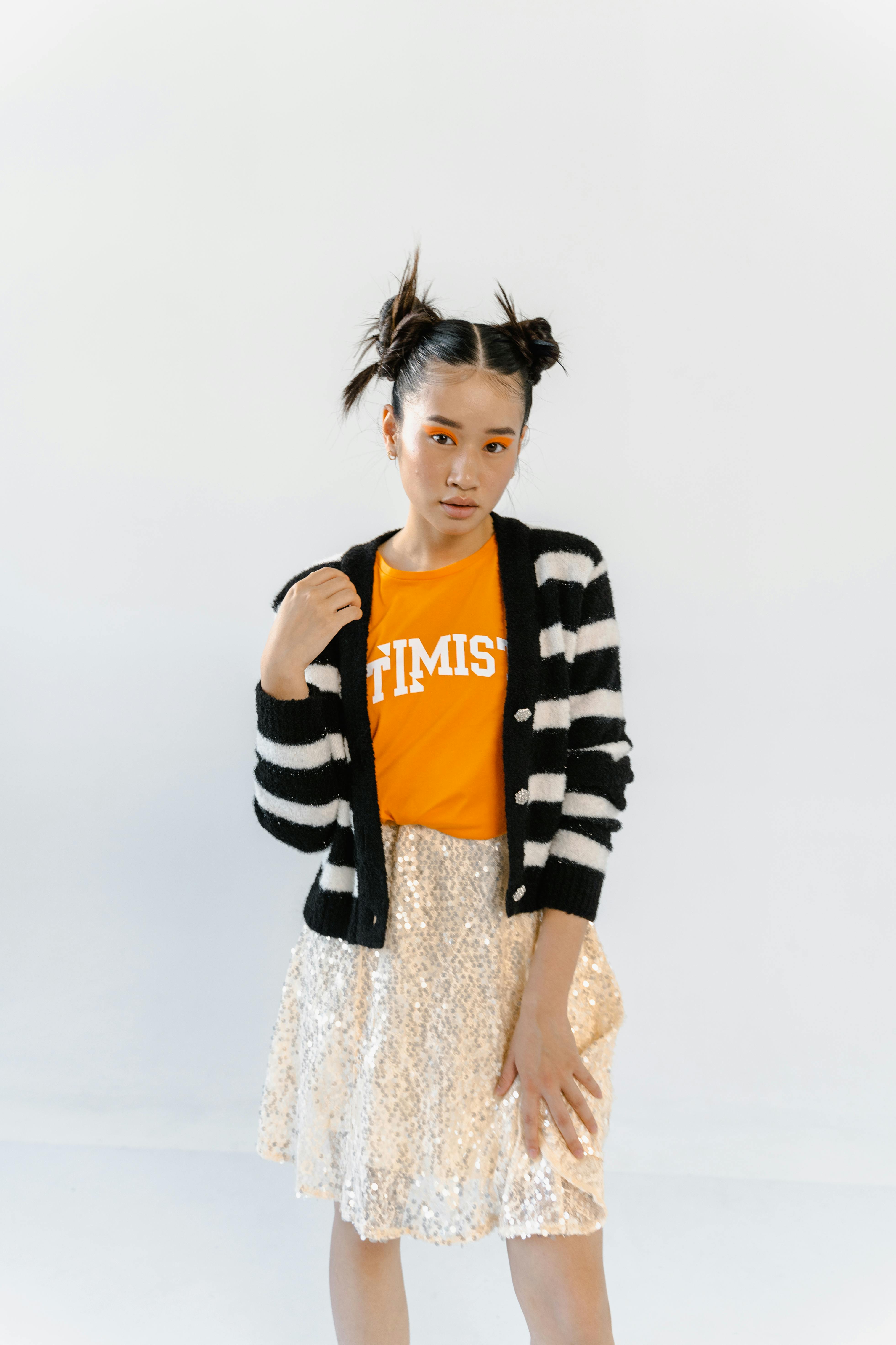 girl in striped cardigan with orange eye makeup