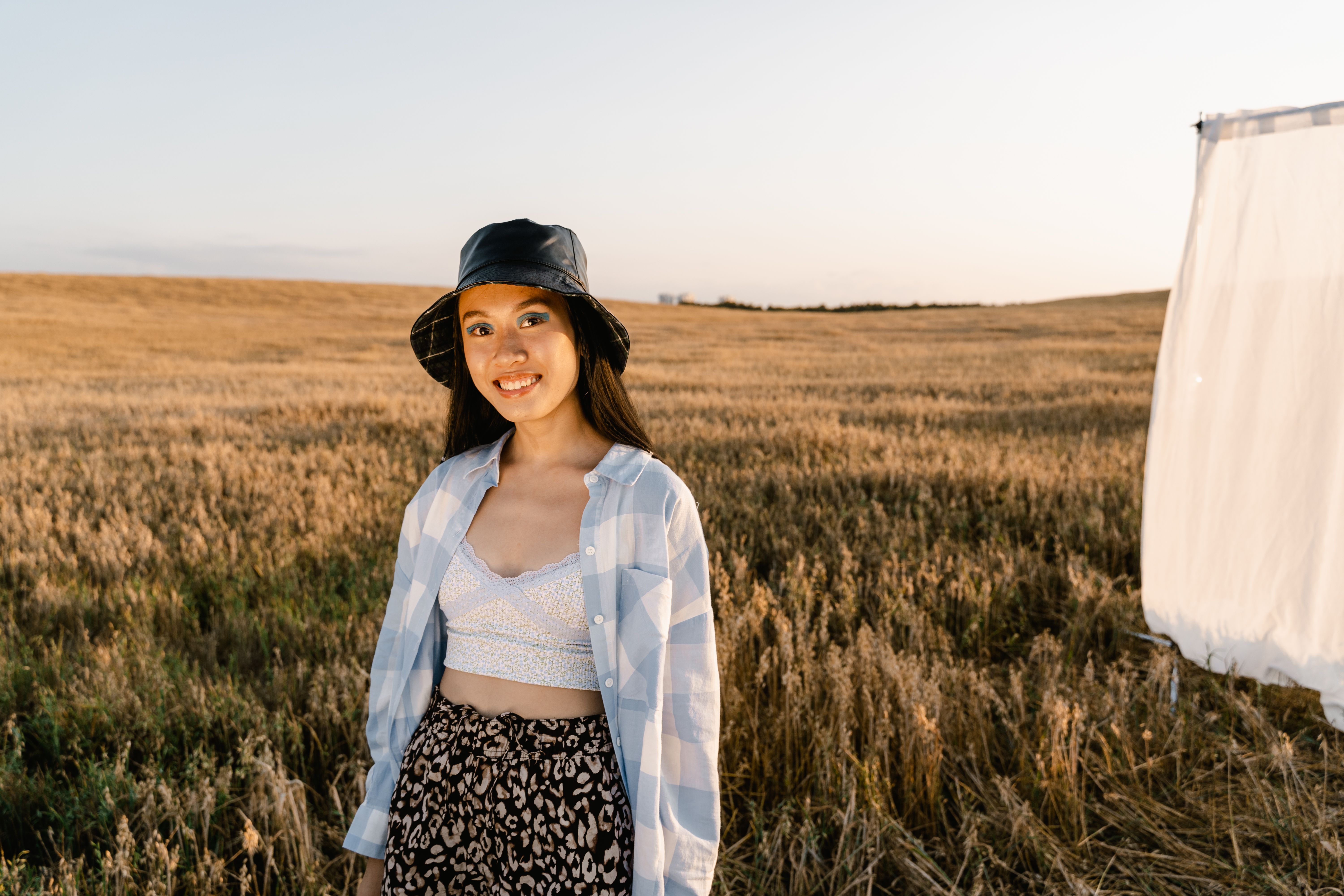 Woman in Plaid Long Sleeve Shirt Standing on Grass Field · Free Stock Photo