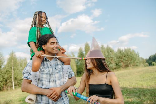 Free Joyful family enjoying quality time outdoors in summer with playful activities. Stock Photo
