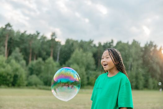 Soap Sud Floating in Front of a Girl With Dreadlocked Hair