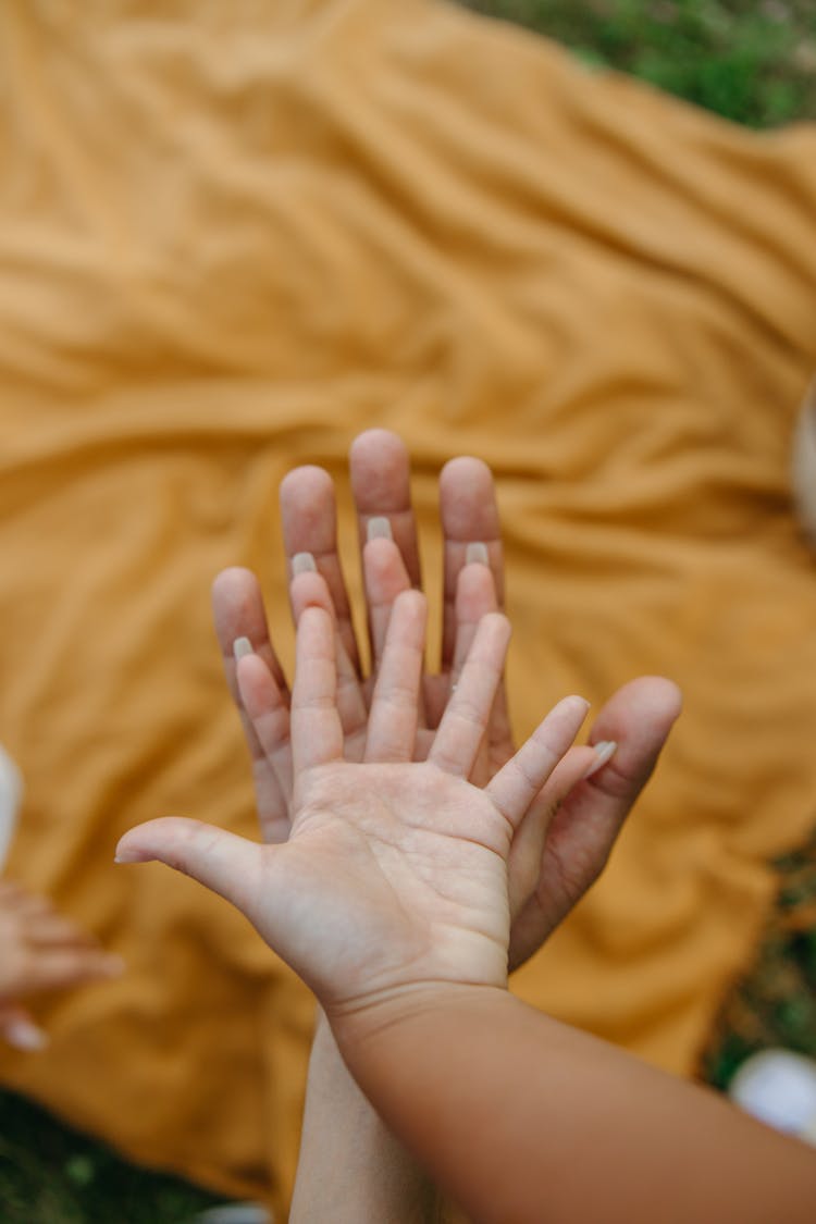 Hands Of Mother Father And Child Placed On Top Of Each Other