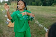 A Girl Poking Bubbles