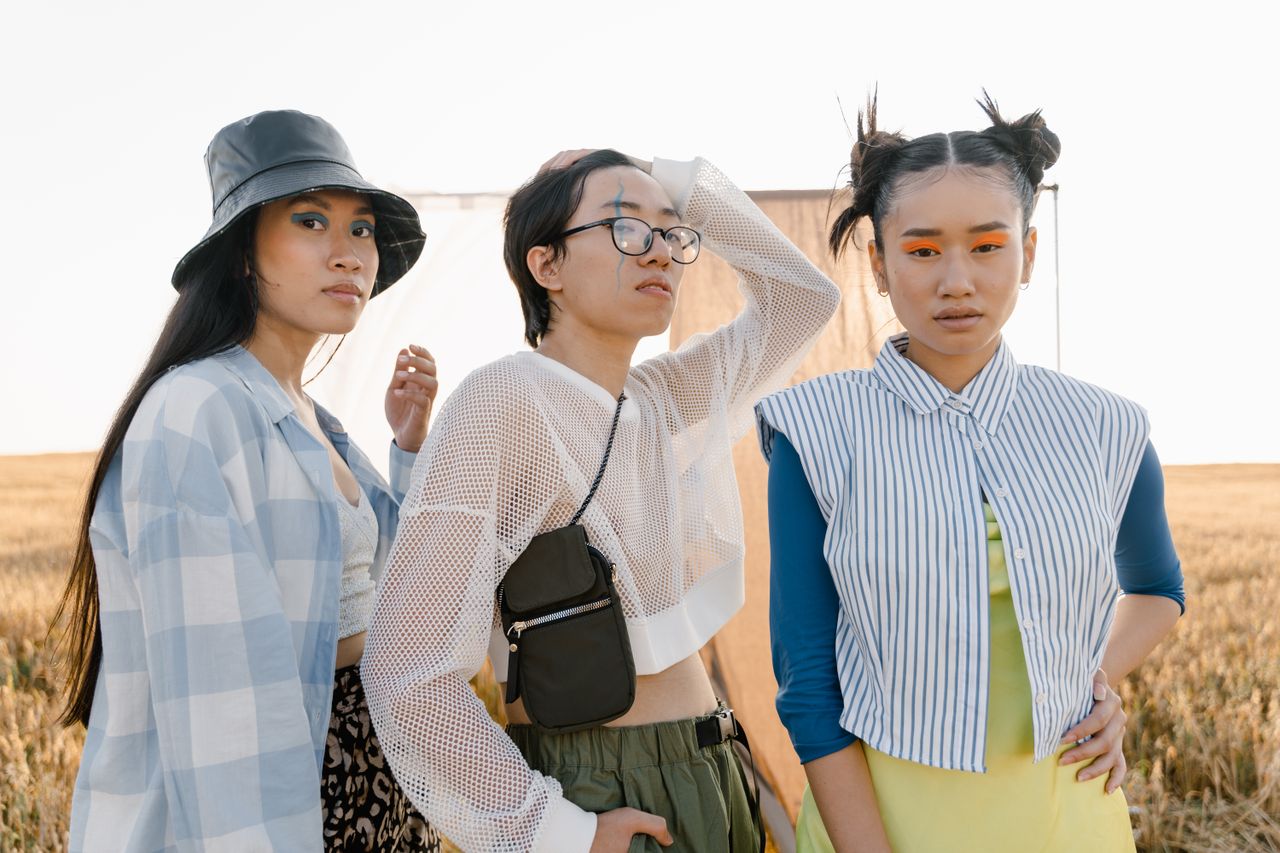 three young adults showcase unique and bold fashion styles outdoors bl