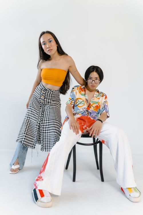 Free Stylish studio photoshoot featuring fashionable Asian models in vibrant outfits. Stock Photo