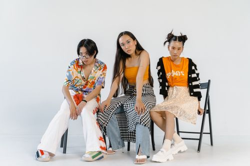 Free Three teenagers showcasing diverse and expressive fashion in a studio setting. Stock Photo