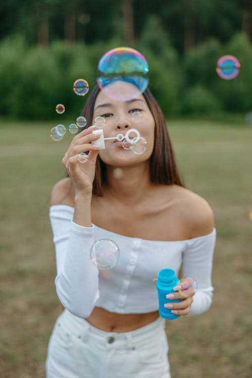 Pretty Woman Plying with Blowing Bubbles