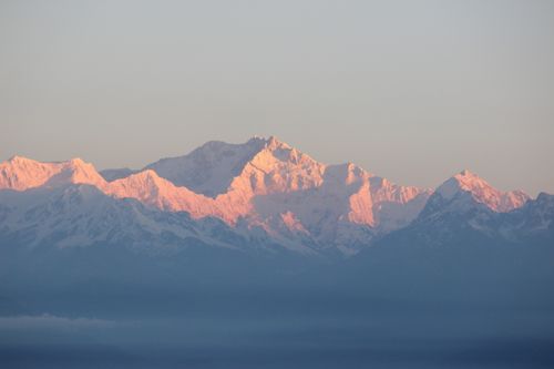 Free A breathtaking view of the snow-covered Himalayas bathed in the warm glow of sunrise. Stock Photo