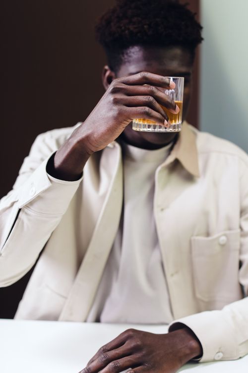 Free Portrait of an adult man savoring whisky indoors. Perfect for lifestyle themes. Stock Photo
