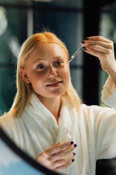 Woman using a dropper to apply facial serum, promoting skincare routine.