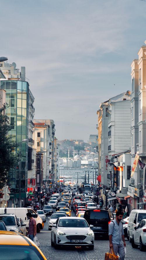Free A vibrant street in Istanbul with traffic, showcasing urban life and architectural diversity. Stock Photo
