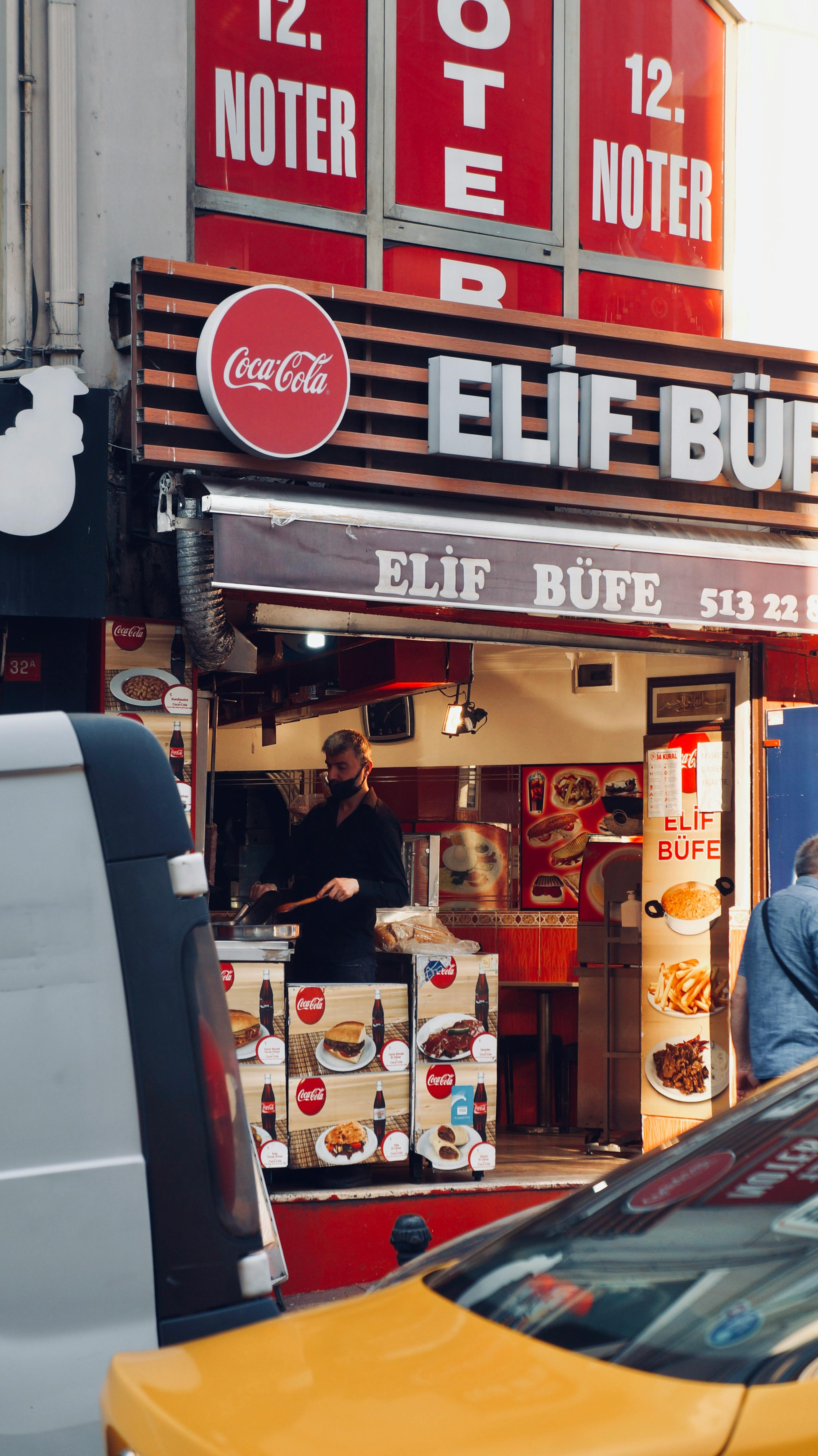 A lively street scene with a busy snack shop in Istanbul, Turkey, highlighting daily urban life.