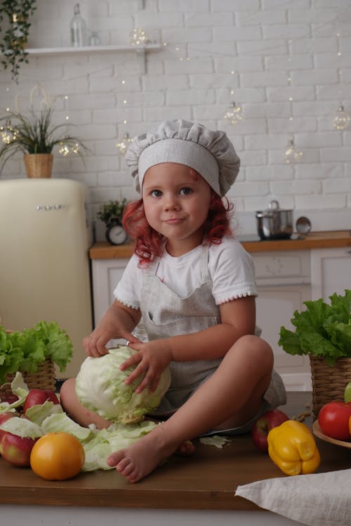 Kid Holding a Cabbage