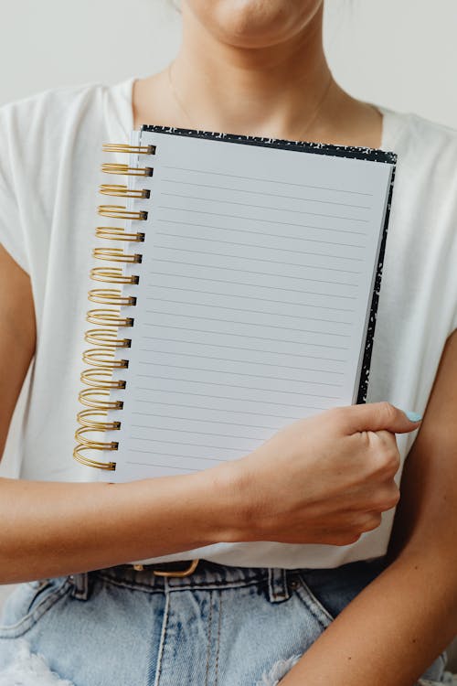 Free Person Holding a Notebook Stock Photo