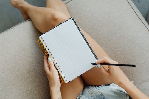 A Person About to Write on a Notebook