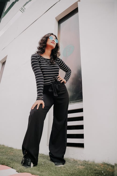 Woman in Striped Long Sleeve Shirt and Black Pants · Free Stock Photo