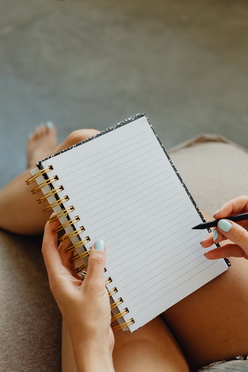 Free Close-up of Holding a Notebook and Pen Stock Photo