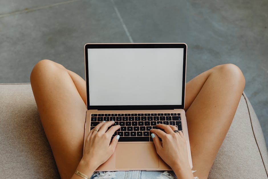 Clay vs Crystal vs Pine Pellet: Odor Control Showdown A person using a laptop with blank white screen while sitting indoors, highlighting a relaxed and modern lifestyle.