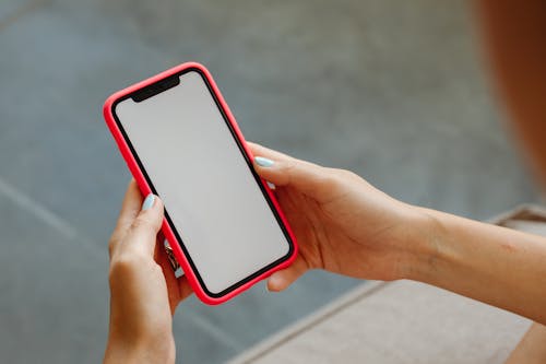 Free Person Holding a Smartphone Stock Photo