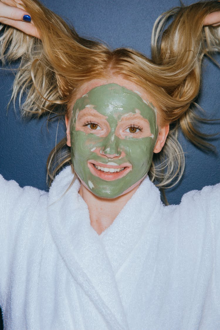 A Woman With Mud Mask Smiling 