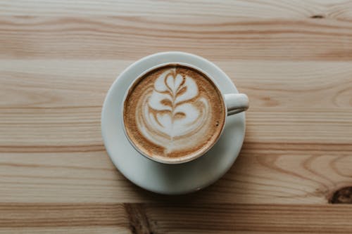 Free Coffee in White Ceramic Teacup on White Ceramic Suacer Stock Photo