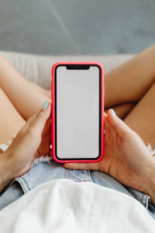 Free Person Holding a Mobile Phone Stock Photo