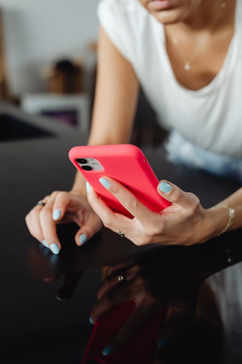 Person Holding a Phone in Red Case