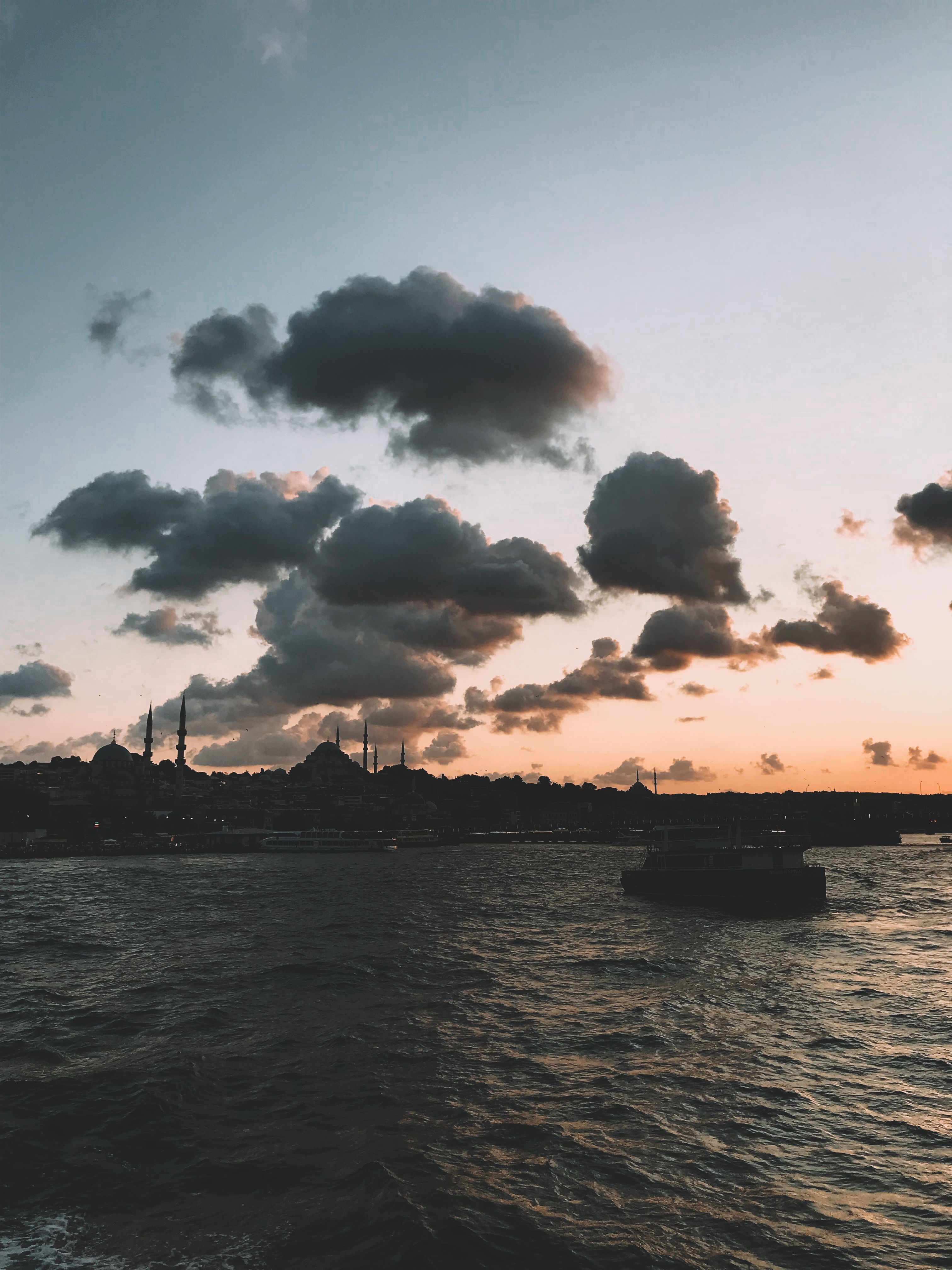 Boat on Sea Under Cloudy Sky During Sunset · Free Stock Photo