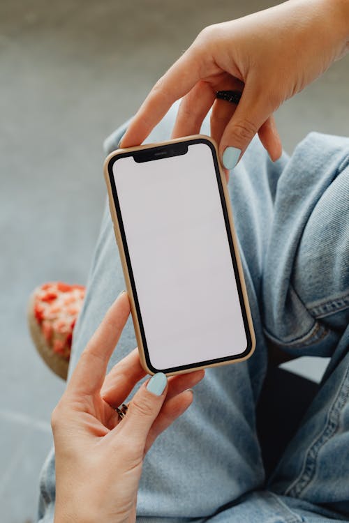 Free Person Holding a Mobile Phone Stock Photo