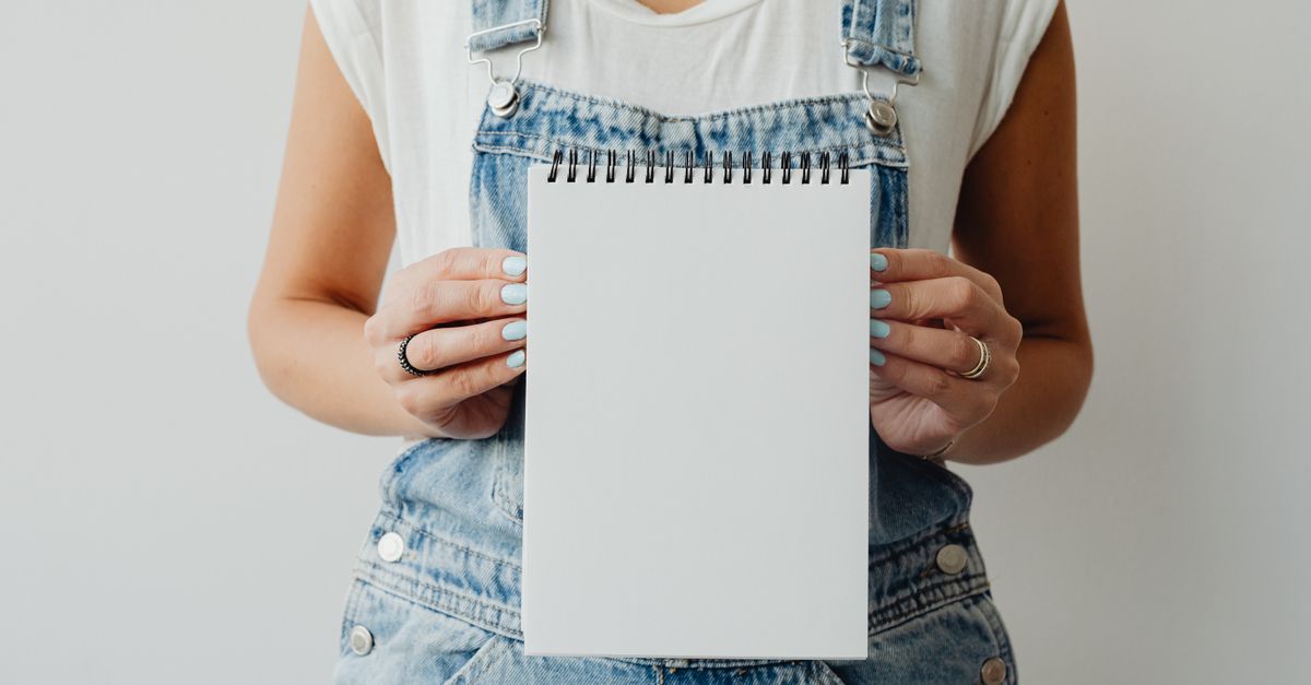 A Person Holding a Blank Notepad · Free Stock Photo
