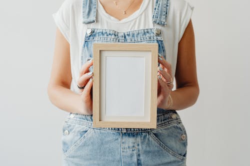 A Woman Holding an Empty Picture Frame