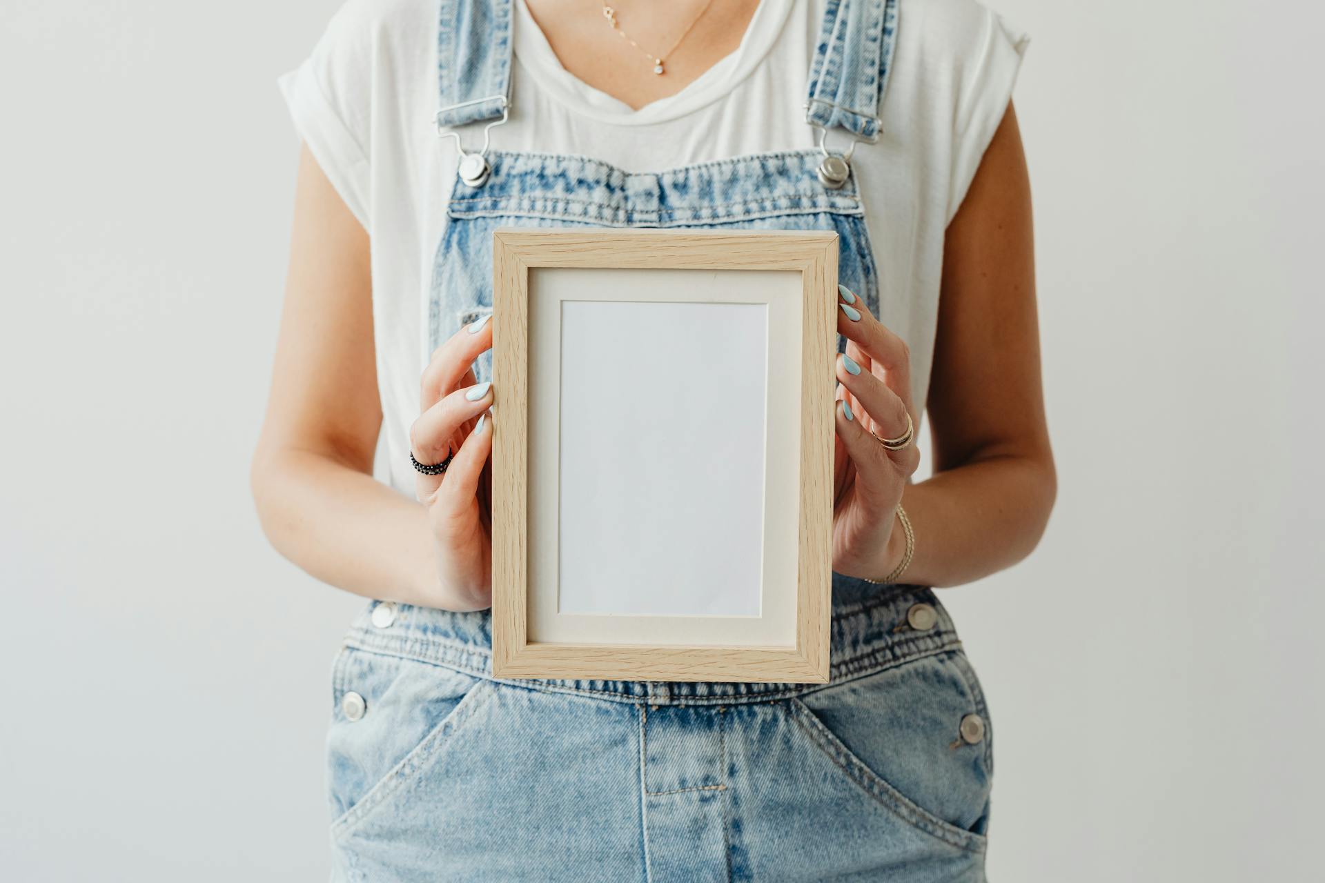 A Woman Holding an Empty Picture Frame