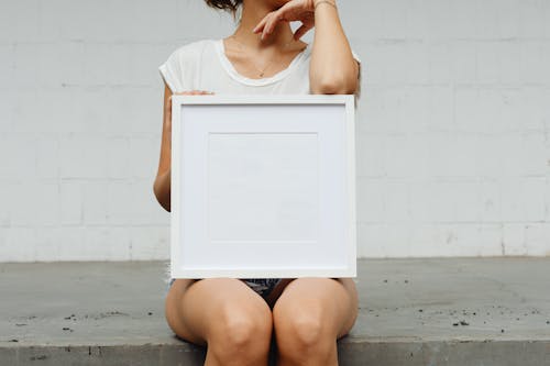 White Frame on a Woman's Lap