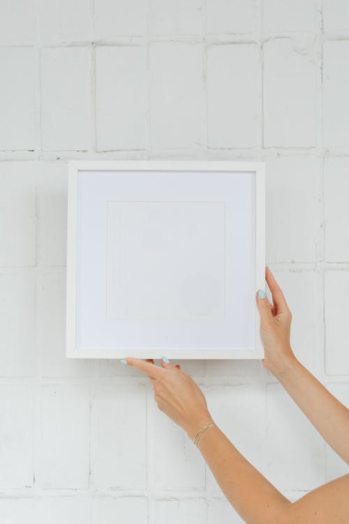 A Person Holding a Blank Picture Frame 